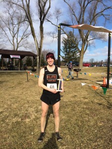 Post-race with my fancy trophy. The finish line banner was not cooperative.